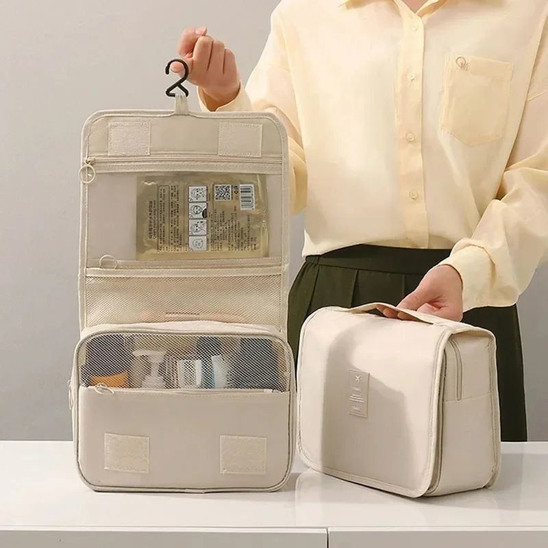 A traveller lifting a wash bag from a packed case